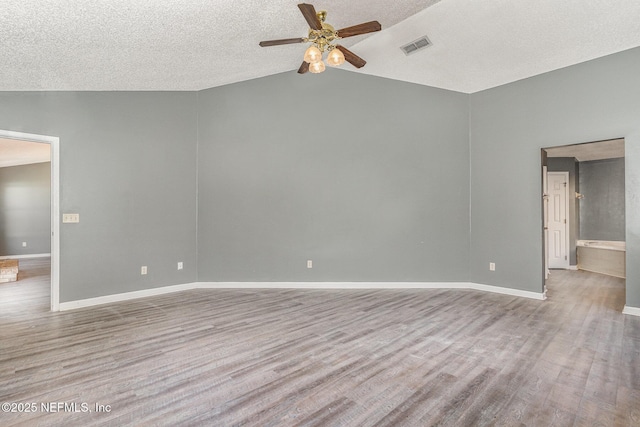 empty room featuring visible vents, baseboards, ceiling fan, and wood finished floors