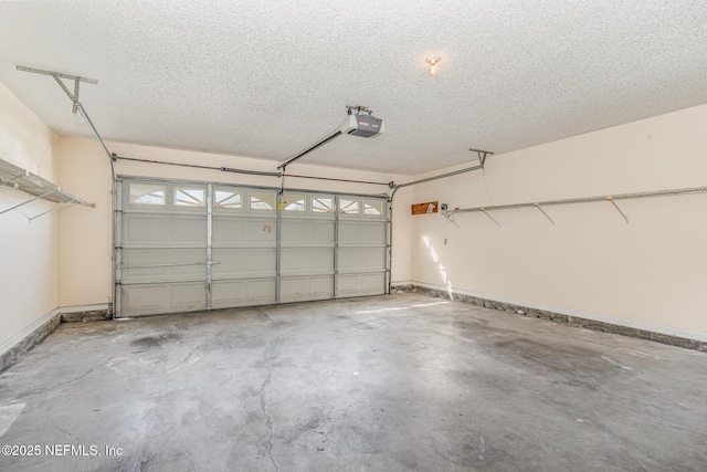 garage featuring a garage door opener and baseboards