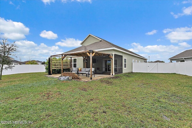 rear view of house with a patio, a lawn, outdoor lounge area, and a fenced backyard