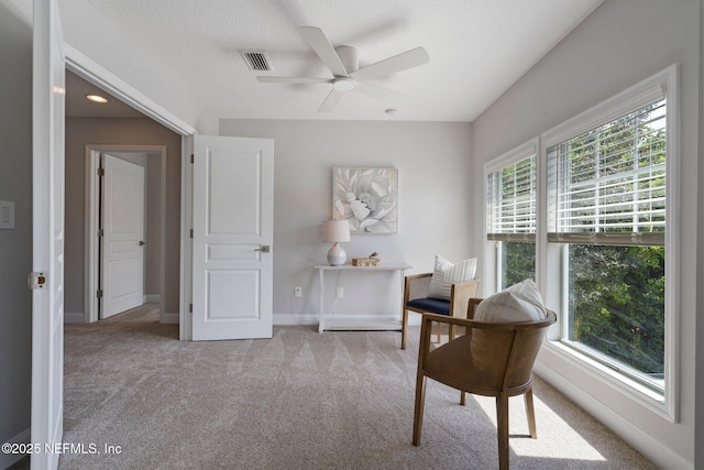 home office featuring visible vents, carpet flooring, ceiling fan, a textured ceiling, and baseboards