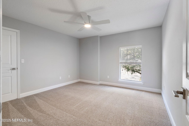 unfurnished room with a ceiling fan, carpet, baseboards, and a textured ceiling