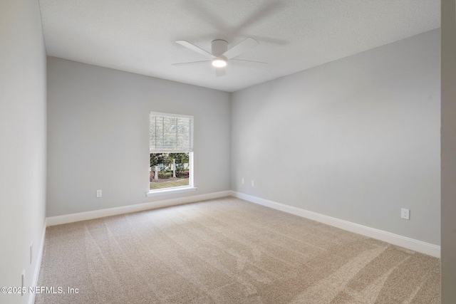 unfurnished room featuring carpet and baseboards