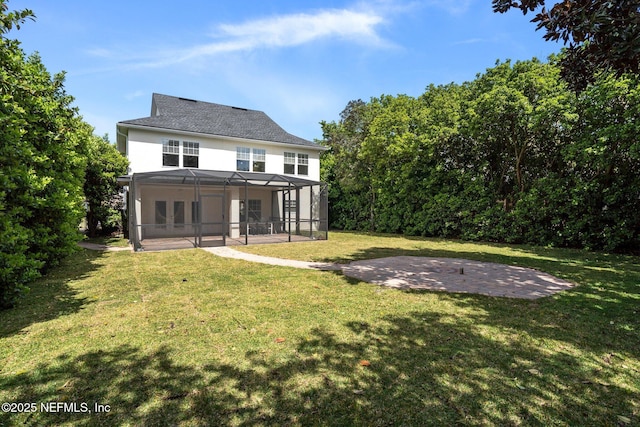 back of property with a yard, a patio area, and a lanai