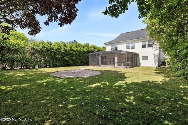 view of yard featuring glass enclosure and a patio area