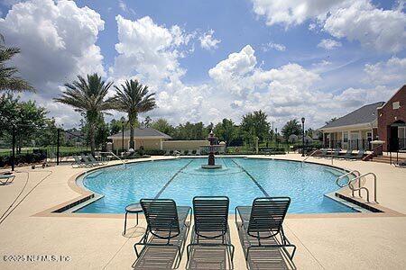 pool featuring fence and a patio