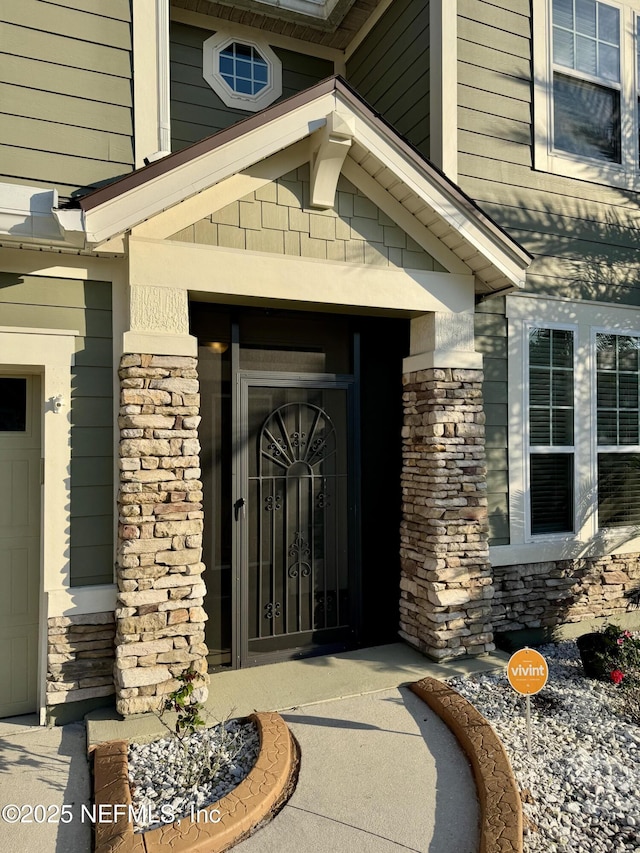 entrance to property featuring stone siding