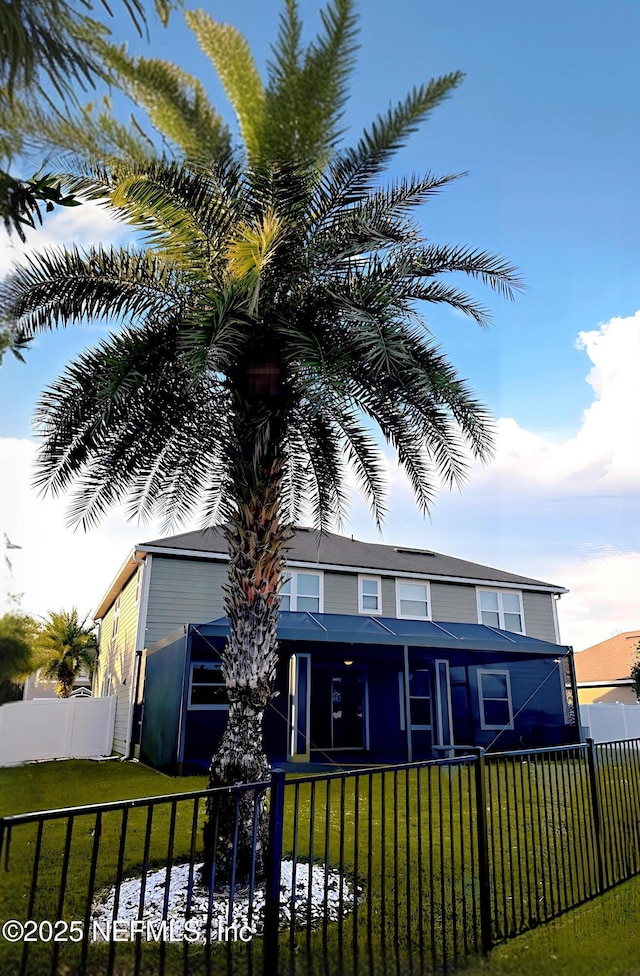 view of front of property with fence and a front lawn