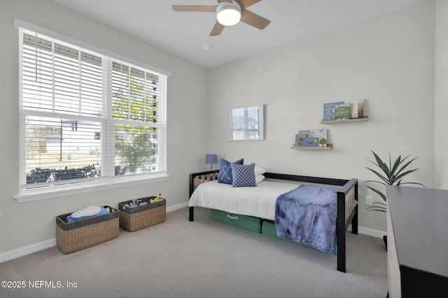 carpeted bedroom featuring a ceiling fan and baseboards