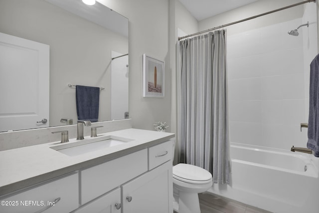 full bath with shower / bath combo, vanity, and toilet