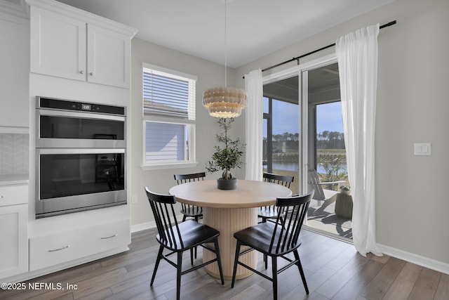 dining area with a healthy amount of sunlight, baseboards, and dark wood-type flooring