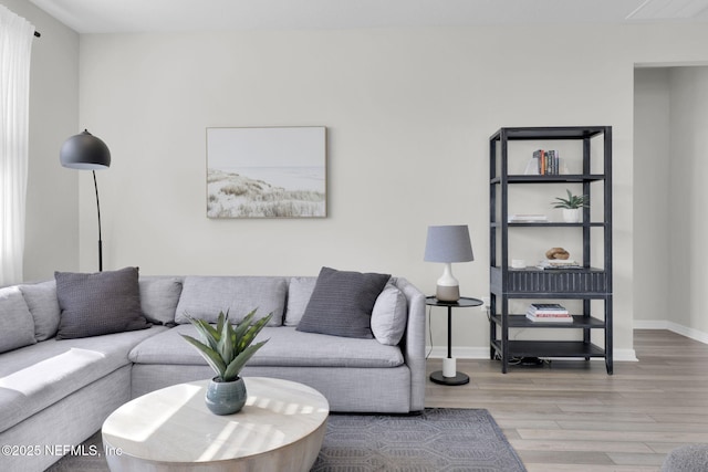 living area with wood finished floors and baseboards