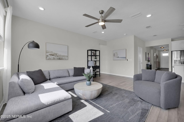 living room with baseboards, visible vents, ceiling fan, wood finished floors, and recessed lighting