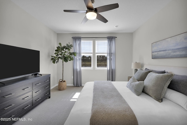 bedroom with light carpet, ceiling fan, and baseboards