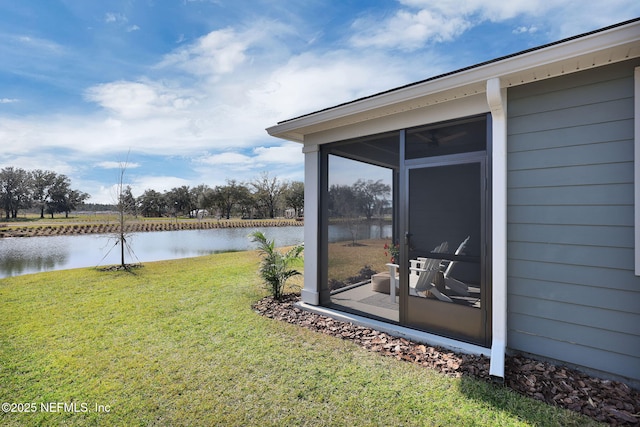 view of yard with a water view and a sunroom