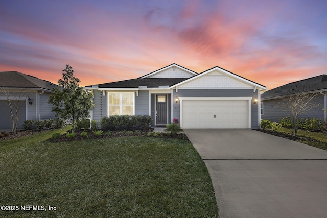 view of front facade with a front yard, driveway, and an attached garage