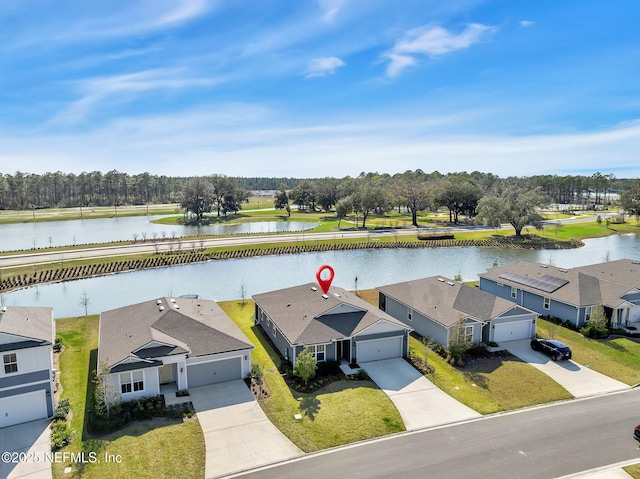 drone / aerial view with a water view and a residential view