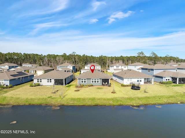 drone / aerial view featuring a water view and a residential view