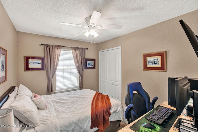 bedroom with a textured ceiling, a closet, and ceiling fan