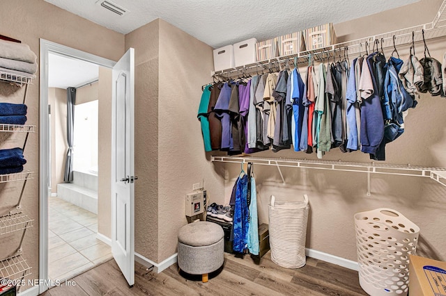 walk in closet featuring wood-type flooring