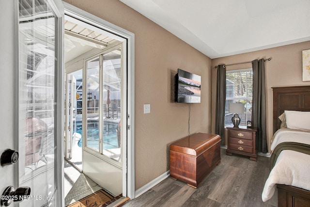 bedroom with dark wood-type flooring and access to exterior