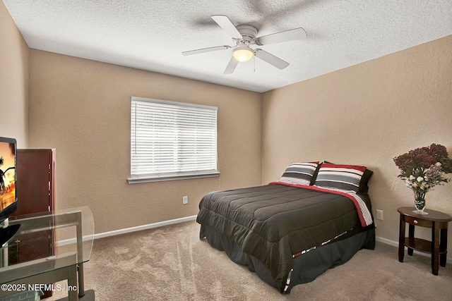bedroom with a textured ceiling, light carpet, and ceiling fan