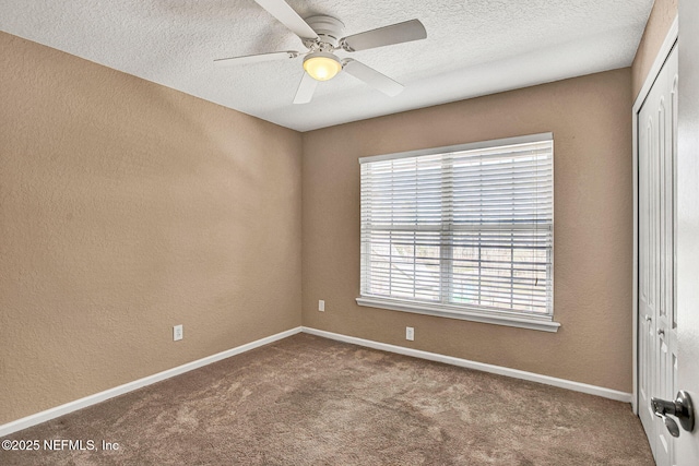 unfurnished bedroom with ceiling fan, carpet flooring, a textured ceiling, and a closet
