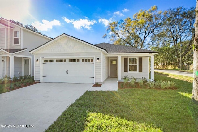 view of front of home with a front lawn, driveway, and an attached garage