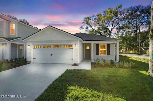 view of front of home featuring a garage, driveway, and a front lawn