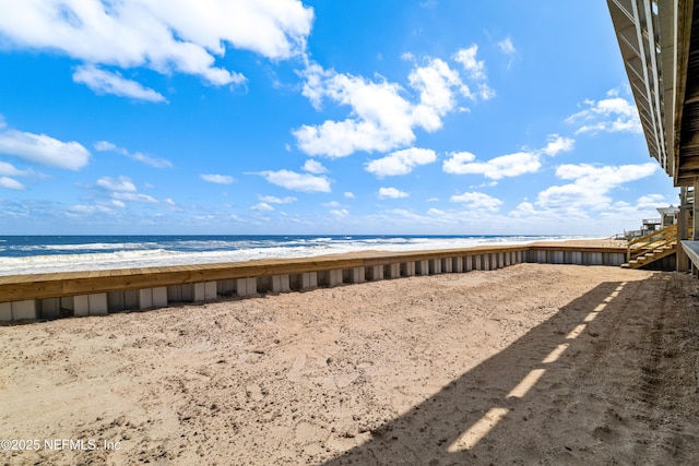 view of yard featuring a water view and a view of the beach