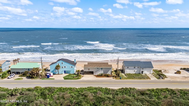 bird's eye view featuring a beach view and a water view