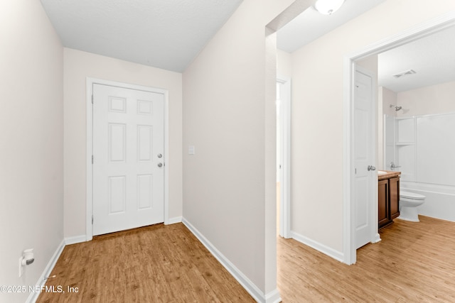 corridor with light wood-type flooring