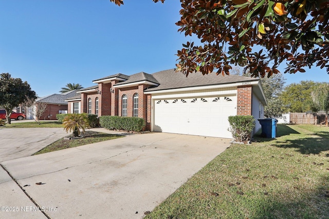 view of front facade featuring driveway, a front lawn, fence, an attached garage, and brick siding