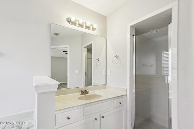 full bath with a shower stall and vanity