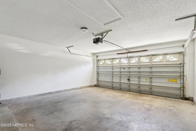 garage with a garage door opener and baseboards