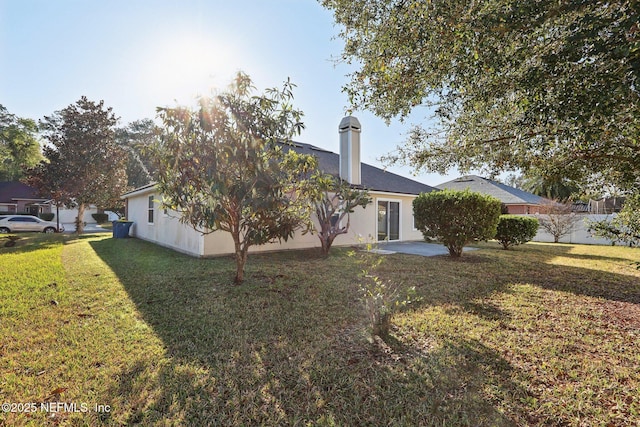 rear view of house with a yard, a patio area, and fence