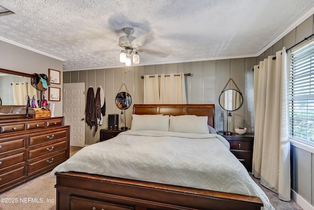 carpeted bedroom featuring a textured ceiling, ornamental molding, and multiple windows