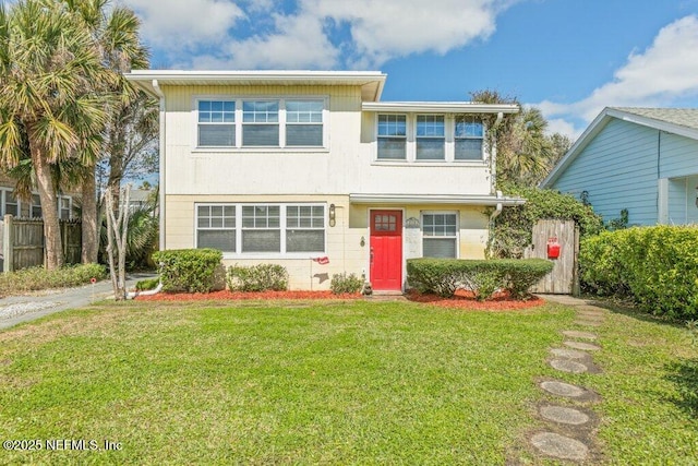 view of front of property featuring a front lawn and fence