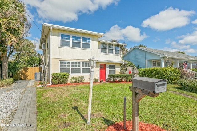 view of front of house with fence, cooling unit, and a front yard