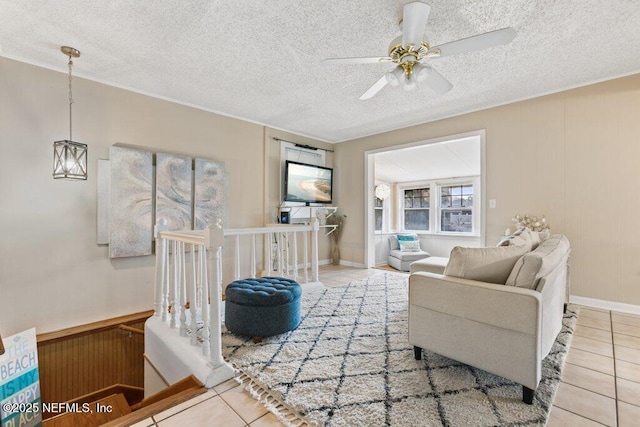 tiled living area with a textured ceiling and a ceiling fan