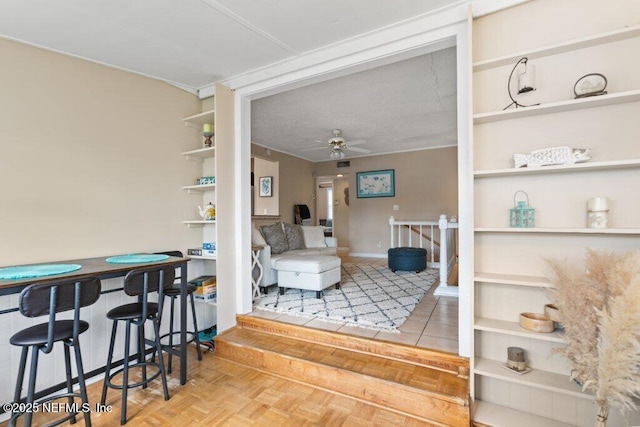 interior space featuring a ceiling fan and built in features