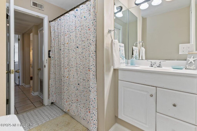 bathroom with curtained shower, tile patterned flooring, vanity, and visible vents