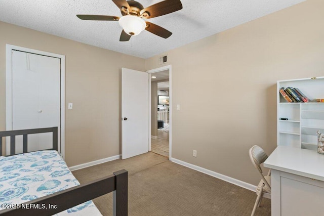 bedroom with light colored carpet, visible vents, a ceiling fan, a textured ceiling, and baseboards