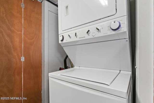 laundry room with stacked washer and dryer and laundry area