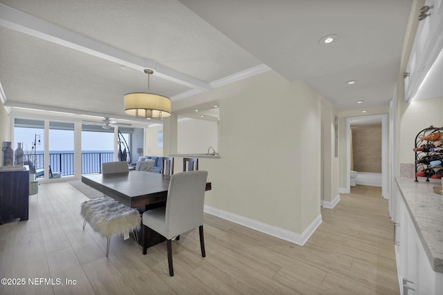 dining room featuring beamed ceiling, recessed lighting, light wood-style floors, and baseboards