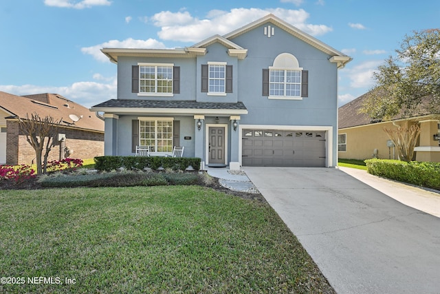 traditional home with concrete driveway, a front lawn, an attached garage, and stucco siding