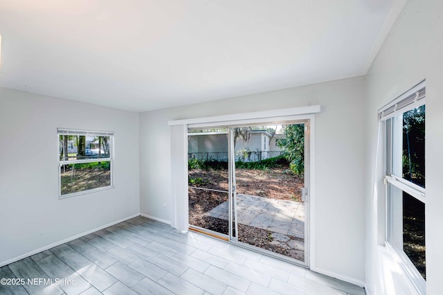 unfurnished room featuring baseboards