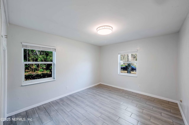 spare room featuring baseboards