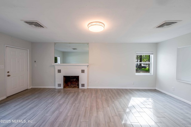 unfurnished living room featuring light wood finished floors and visible vents