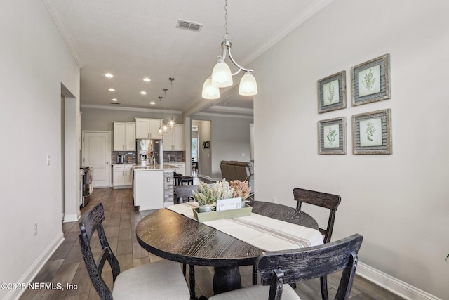 dining room featuring visible vents, baseboards, dark wood-style floors, crown molding, and recessed lighting