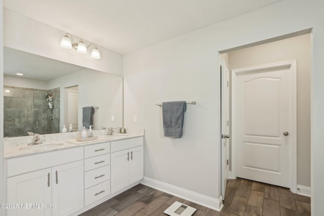 full bathroom with wood tiled floor, a sink, and a shower stall